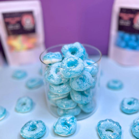 Gefriergetrocknete Blaubeerringe (Halal) in einem Glasbehälter mit violett-blauer Färbung. Produktdarstellung von Astrocat Candy.